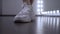 foots of a young girl rehearsing a dance in the studio in front of the mirror.