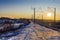 Footsteps along the railway tracks in winter at sunset