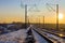 Footsteps along the railway tracks in winter at sunset