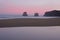 Footsteps on the beach with the first lights of dawn over the sea of Hendaia beach