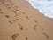 Footsteps footprints on the beach sand