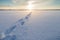 Footsteps on snow at a frozen lake