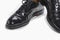 Footwear Concept. Closeup of Pair of Formal Male Stylish Black Polished Oxford Leather Laced Shoes Placed Together Over White