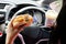 forbidden and perilous with close-up of woman\\\'s hand, holding burger and coffee, While driving