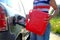 Forced stop. Ran out of gas in the tank of the car. A woman fills the car with gasoline from a spare tank. Canister of 10 liters