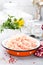 Forcemeat. Raw ground chicken meat in bowl on white kitchen table. Fresh minced chicken breast meat