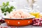 Forcemeat. Raw ground chicken meat in bowl on white kitchen table. Fresh minced chicken breast meat