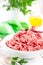 Forcemeat. Raw ground pork meat in bowl on white kitchen table. Fresh minced meat