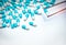 Forceps pick white-blue capsule from group of capsule pills. Drugs choose. Antibiotic drug selection. Antibiotic drug resistance