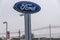 The Ford Motor Company logo as seen on a tall sign at a car dealership. Ford`s headquarters are in Dearborn, Michigan