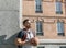 Forefront of a handsome young basketball player leaning on a huge column in the city of Madrid