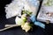 Foreground boutonniere, wedding rings and the garter of the bride in the background