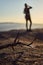 Foreground of a dead stick, with a defocused bacground of a woman posing