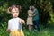 In foreground girl holding a flower. In background parents embracing each other looking at her.