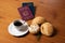 In the foreground, Italian and Brazilian passport, in the background and blurred a small cup of coffee and three loaves of bread w