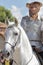 Foreground of man dressed as don quijote de la mancha mounted on a white horse