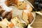 Foreground of a sliced cupcake with raisins and powdered sugar on a plate and a wooden background