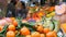 In foreground tangerines with green leaves and exotic fruits. Vegetable market . Huge selection of various vegetables