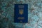 Foreign passport of a Ukrainian on a dark background with copy space. The concept of Ukrainians going abroad to earn