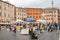 Foreign tourists and locals strolling on trips between the work of street artists in the portrait between the historic Piazza Navo