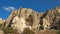 Foreign tourists visiting fabulous natural park with carved rock christian church from volcanic tuff formation.