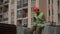 Foreman builder male young caucasian at construction site during break resting drinking coffee and looking mobile phone