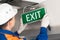 Foreman completes installation  of lighting signs emergency exit