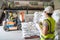 A foreman is controlling a forklift driver in alum or chemical warehouse