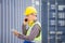 Foreman dock worker in hardhat and safety vest checking containers box from cargo, Engineer man with digital tablet checking and