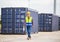 Foreman dock worker in hardhat and safety vest control loading containers box from cargo, Engineer with clipboard checklist in