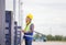 Foreman dock worker in hardhat and safety vest control loading containers box from cargo, Engineer with clipboard checklist in