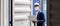 Foreman engineer man wearing protection face mask and safety helmet using laptop checking containers in cargo ship for import