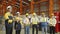 Foreman and group of workers applaud after factory manager is successfully trained