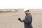 Foreman in helmet surfing internet by tablet on construction site.