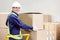 Foreman Holding Cardboard Box in Warehouse