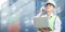 Foreman holding laptop computer talking on the walkie-talkie control loading Containers box at warehouse logistic in Cargo freight