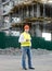 Foreman in jacket posing against building in scaffolding