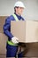 Foreman Lifting Cardboard Box At Warehouse