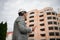 A foreman looking at the new modern building on an industrial background. Building technologies concept. Copy space.