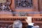 The foreman of the procession giving instructions and encouraging the costaleros bearers under the platform throne before hit