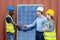 Foreman shaking hand to a Businessman and his woman colleague team in front of solar panels . Solar panels in the field