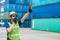 Foreman shipping staff worker working to control loading cargo port logistic for import export goods at container warehouse