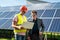 Foreman showing photovoltaic detail businessman at solar energy station