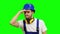 Foreman stands and looks into the distance and smiles. Green screen