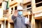 Foreman with stopping gesture showing disinfectant and wearing mask with hardhat.