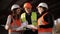 The foreman tells the two women inspectors on the progress of construction works.