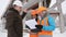 The foreman and two women inspector in the winter, inspect the construction site located behind them in the background.