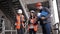 The foreman and two women inspectors to discuss the plan of work performed on construction or restoration of the