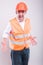 Foreman wearing reflective vest and hardhat screaming