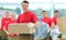 Foreman and workers with boxes of building materials